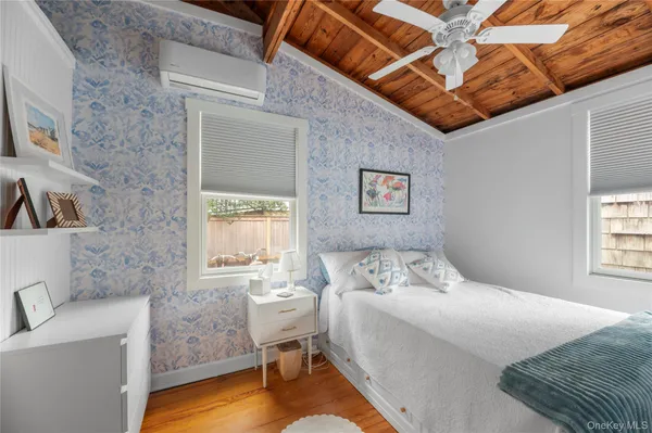 a bedroom with two beds and a window