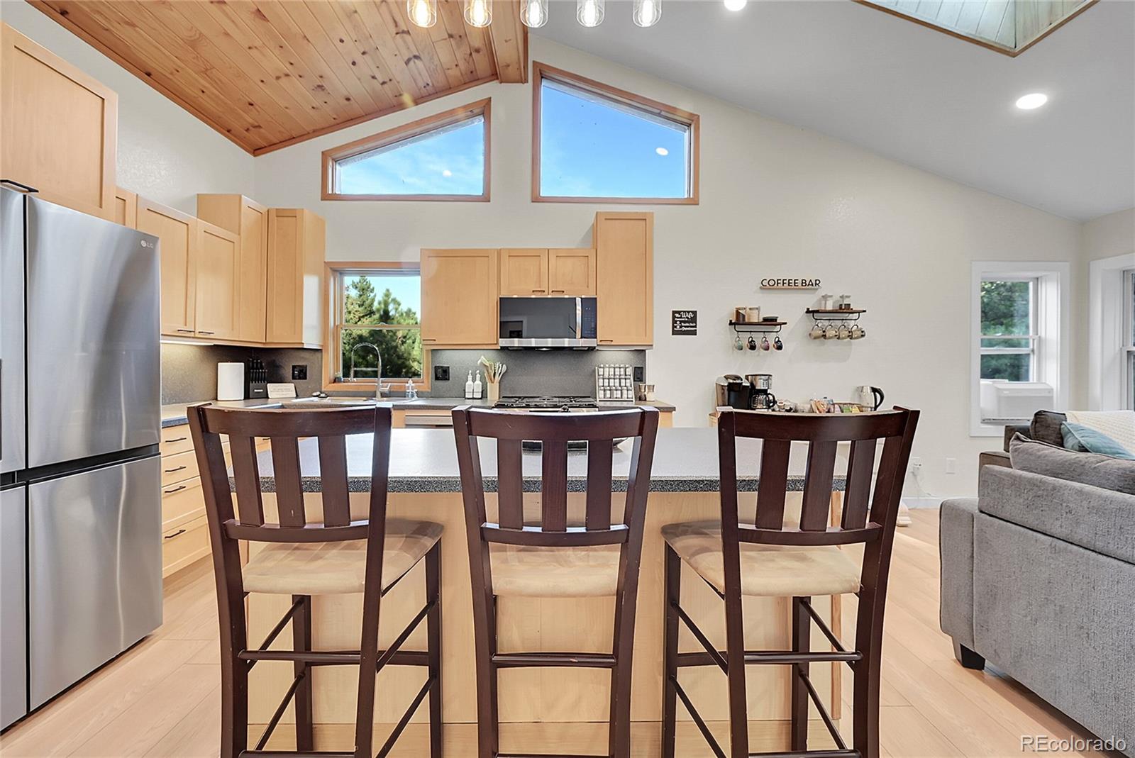 342 Brook Circle Boulder, CO 80302 - Photo 5 of 28 a kitchen with stainless steel appliances a dining table chairs refrigerator and sink
