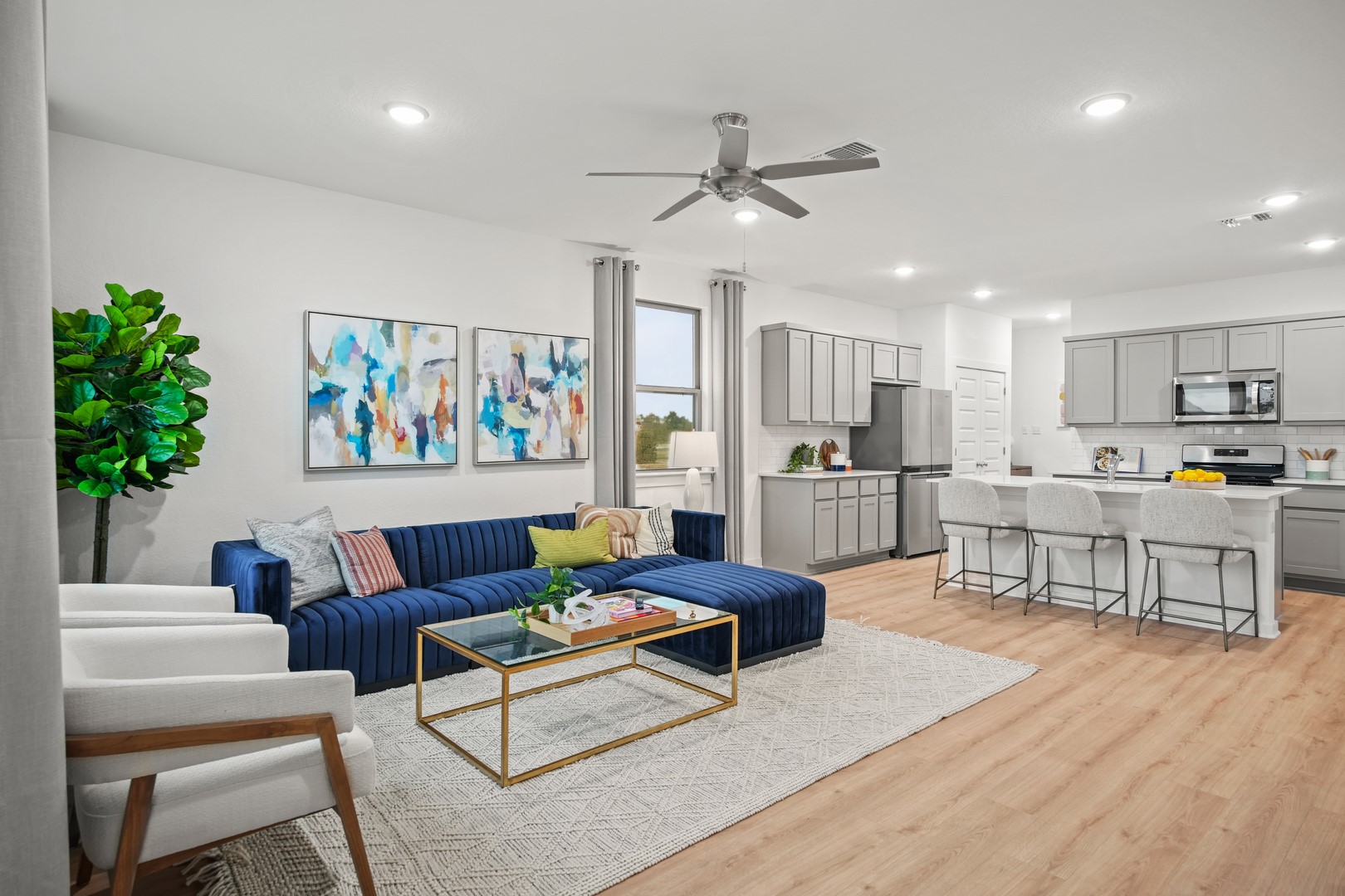 190 Hornet Street Elgin, TX 78621 - Photo 19 of 40 a living room with kitchen island furniture and a kitchen view