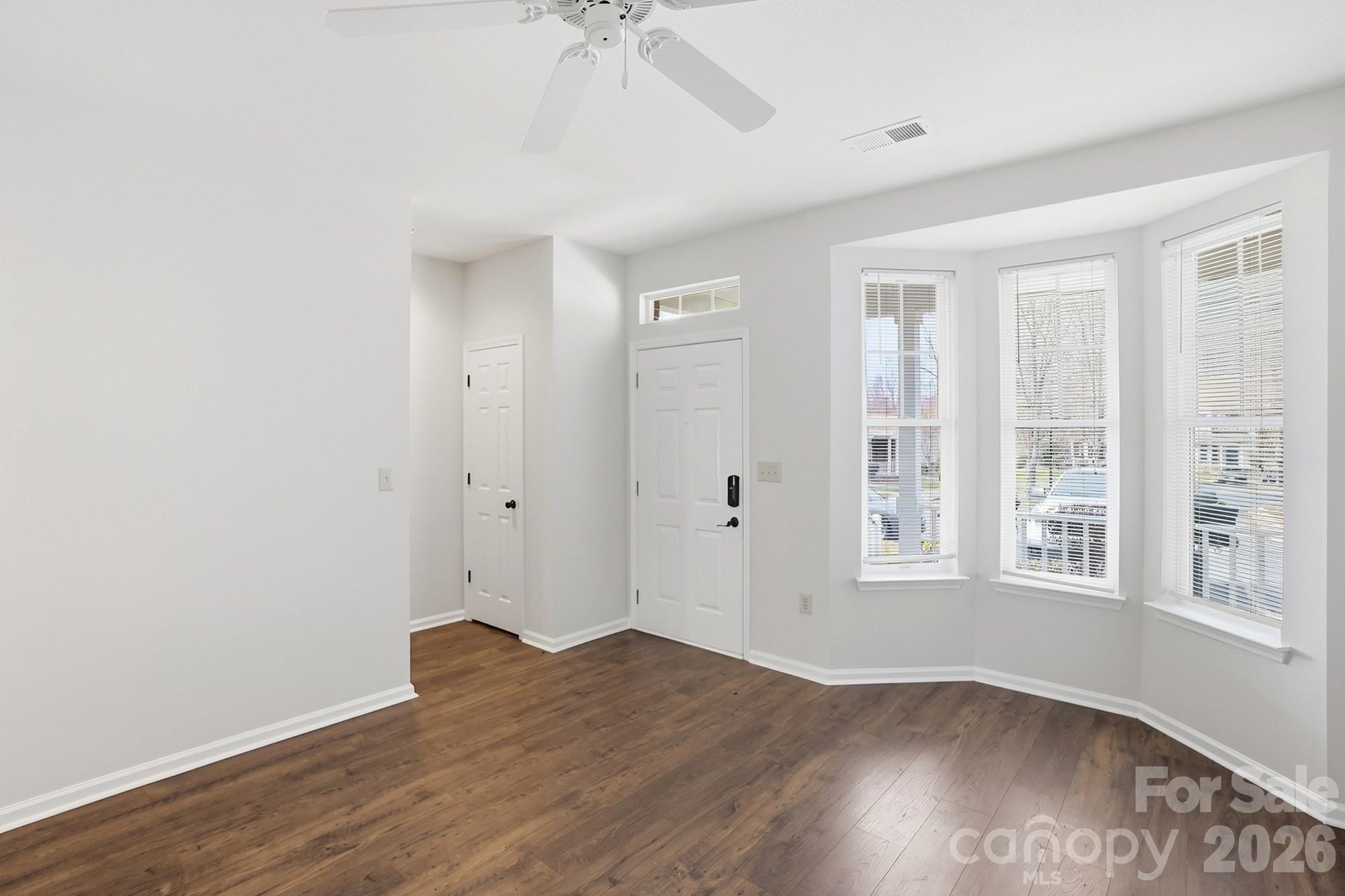 711 Stone Village Drive Fort Mill, SC 29708 - Photo 12 of 46 an empty room with wooden floor and windows