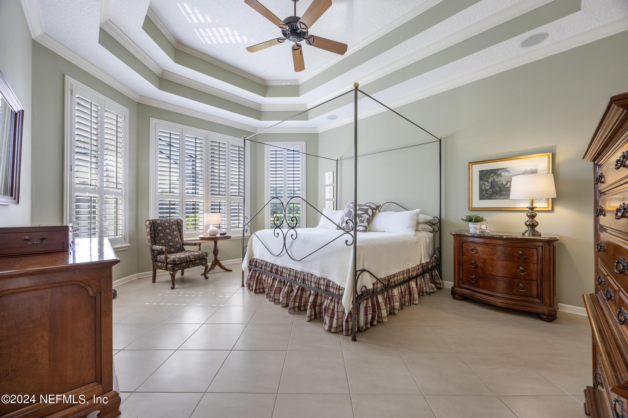 348 Fiddlers Point Drive St. Augustine, FL 32080 - Photo 22 of 58 a bedroom with a bed and a chandelier fan