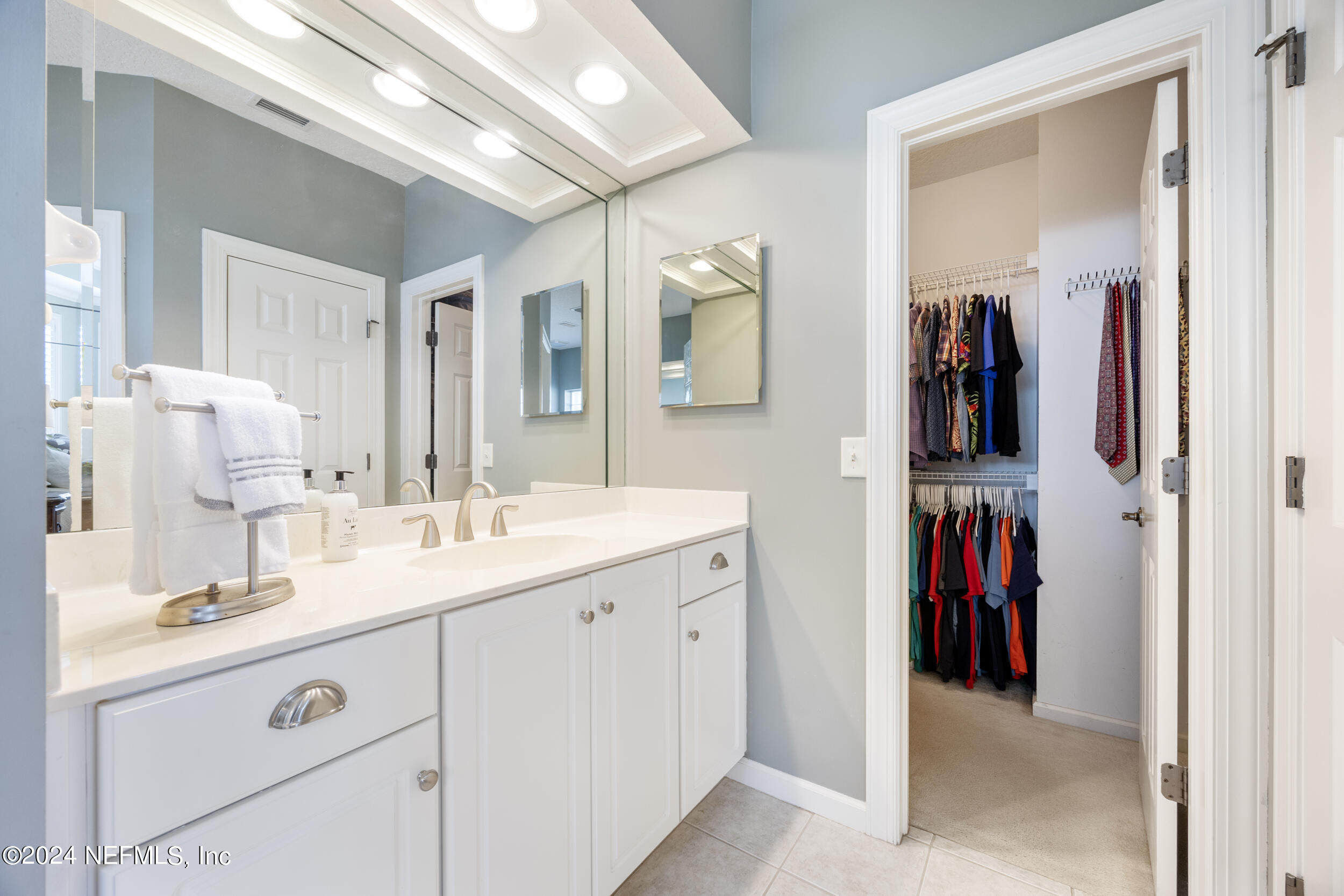 348 Fiddlers Point Drive St. Augustine, FL 32080 - Photo 24 of 58 a en suite bathroom with a double vanity sink and a mirror