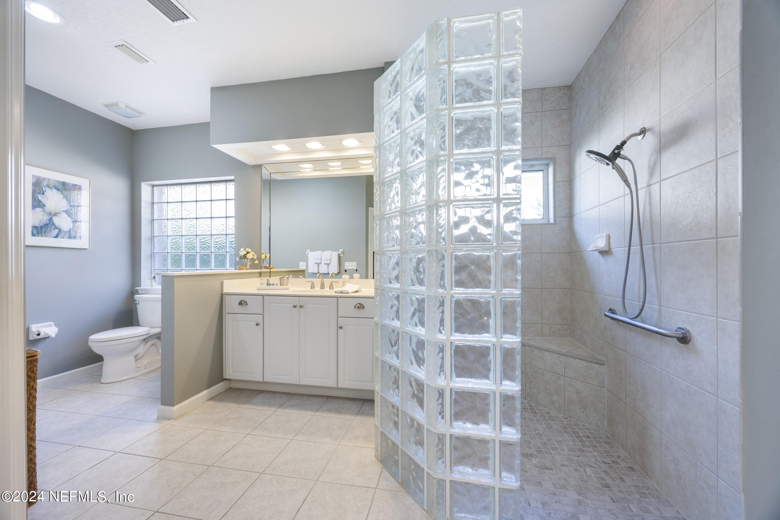 348 Fiddlers Point Drive St. Augustine, FL 32080 - Photo 25 of 58 a bathroom with a double vanity sink toilet and shower