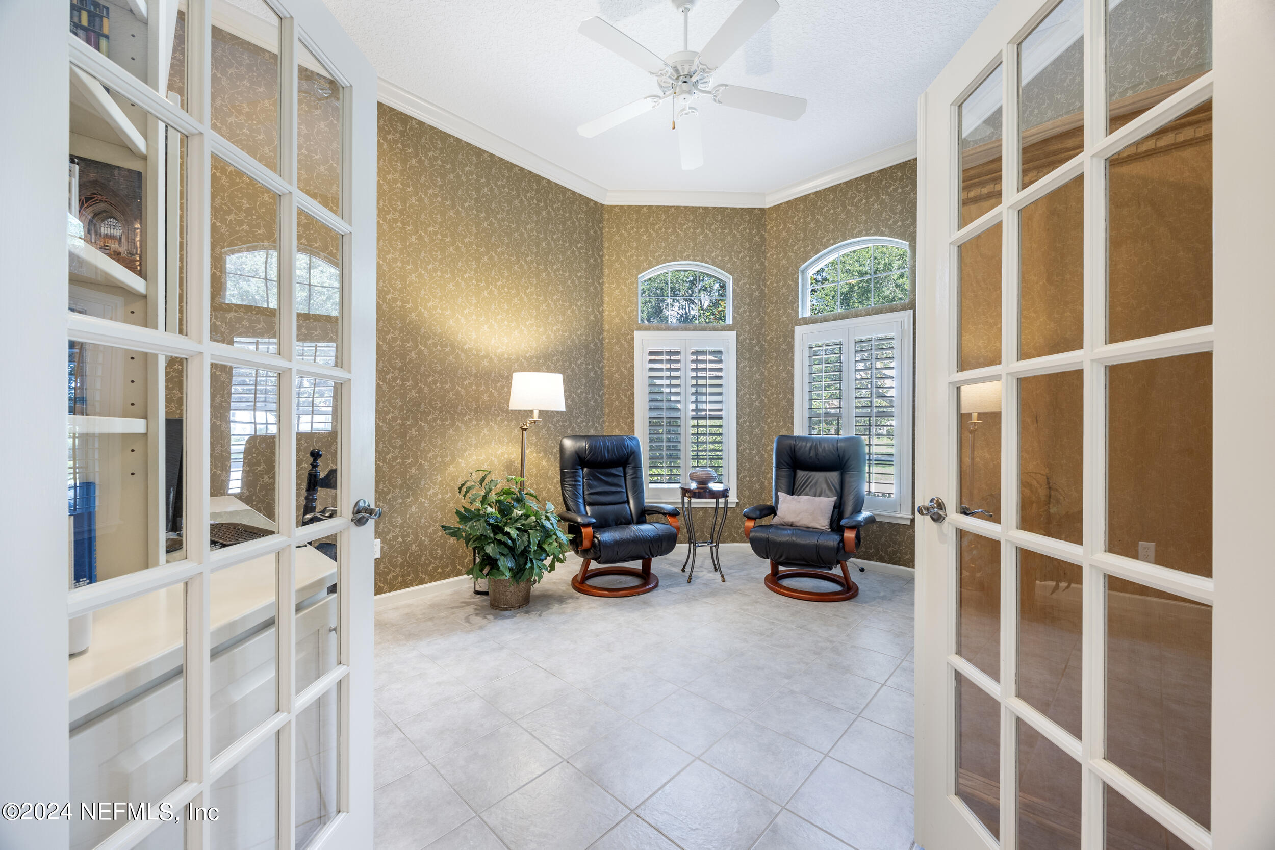 348 Fiddlers Point Drive St. Augustine, FL 32080 - Photo 27 of 58 a living room with furniture and a large window