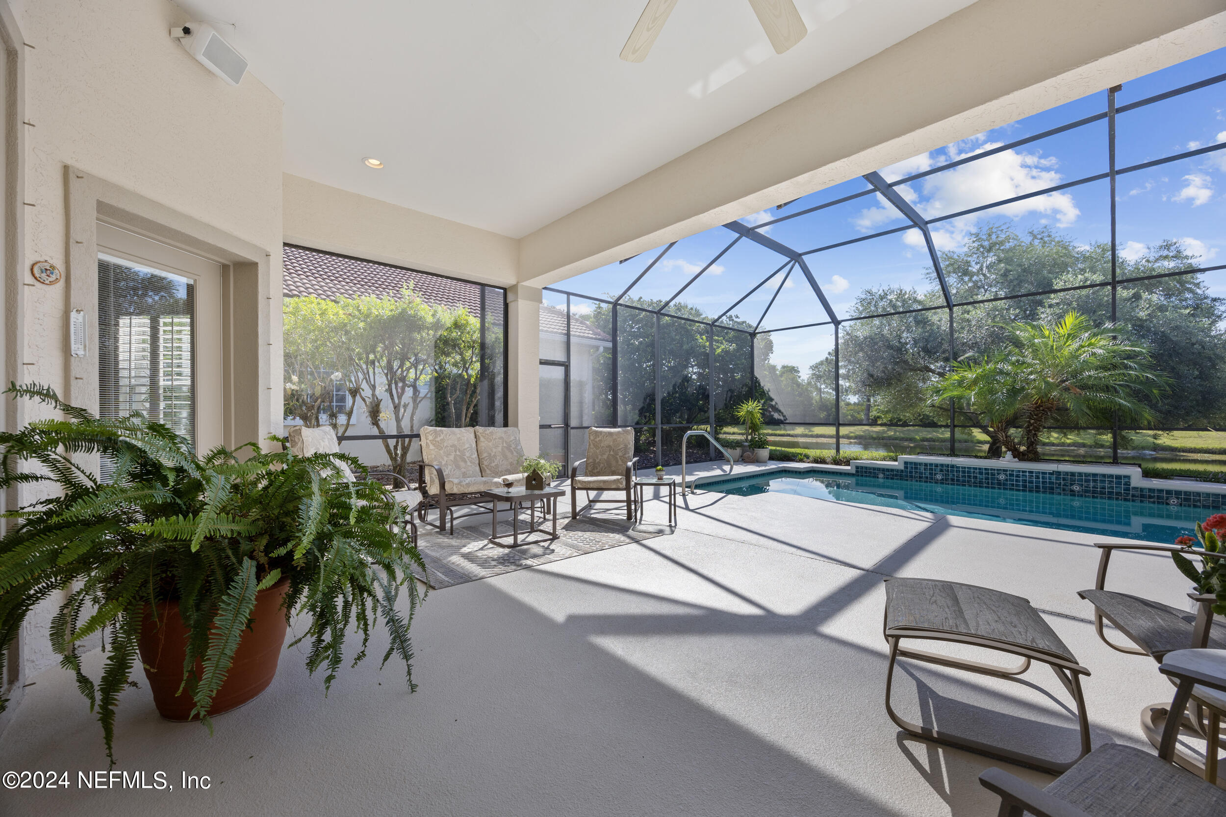 348 Fiddlers Point Drive St. Augustine, FL 32080 - Photo 32 of 58 a view of a patio with a table and chairs