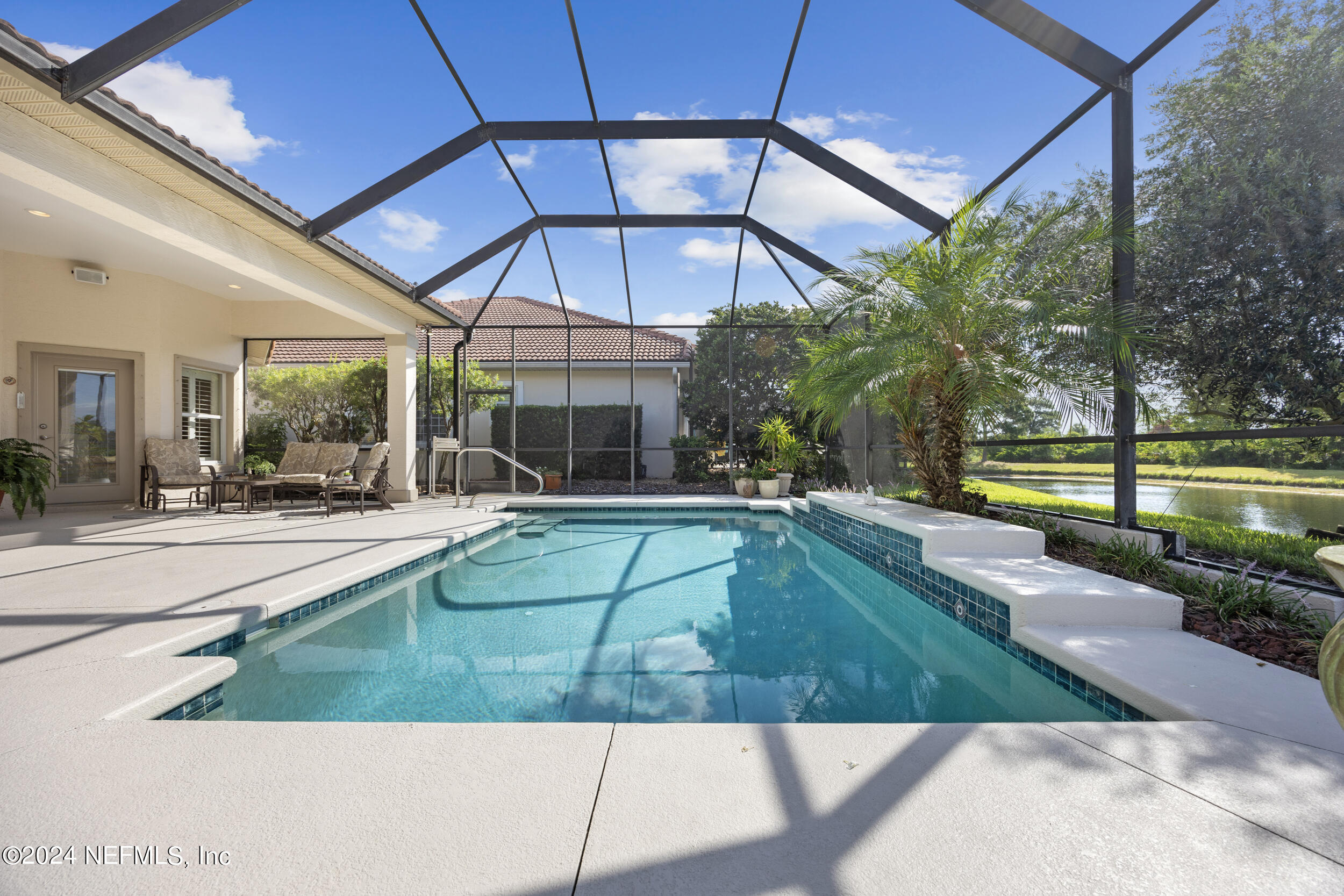 348 Fiddlers Point Drive St. Augustine, FL 32080 - Photo 36 of 58 a view of a swimming pool with a lounge chairs
