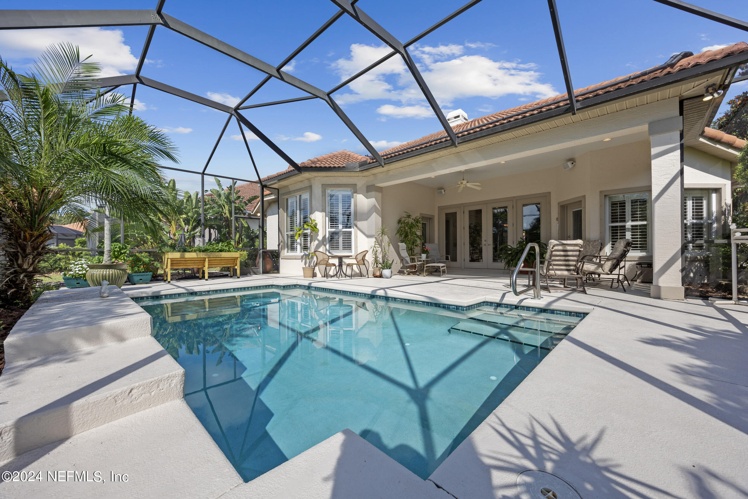 348 Fiddlers Point Drive St. Augustine, FL 32080 - Photo 40 of 58 a view of a swimming pool with a patio