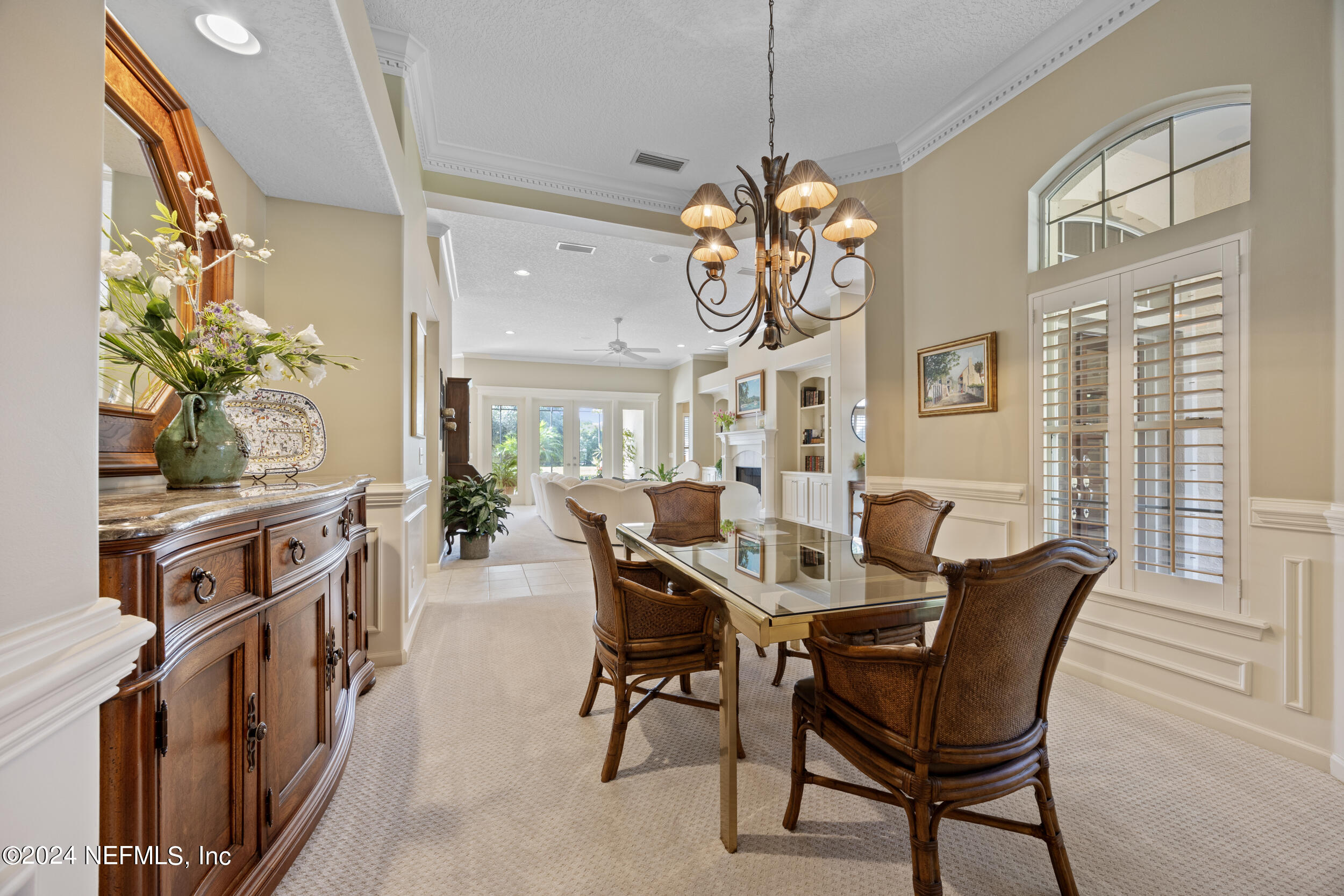 348 Fiddlers Point Drive St. Augustine, FL 32080 - Photo 4 of 58 a view of a dining room with furniture a chandelier and large windows