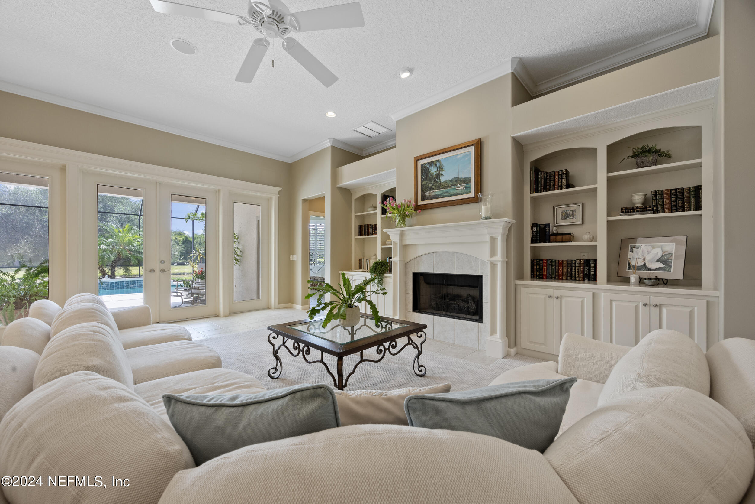 348 Fiddlers Point Drive St. Augustine, FL 32080 - Photo 6 of 58 a living room with furniture fireplace and a large window