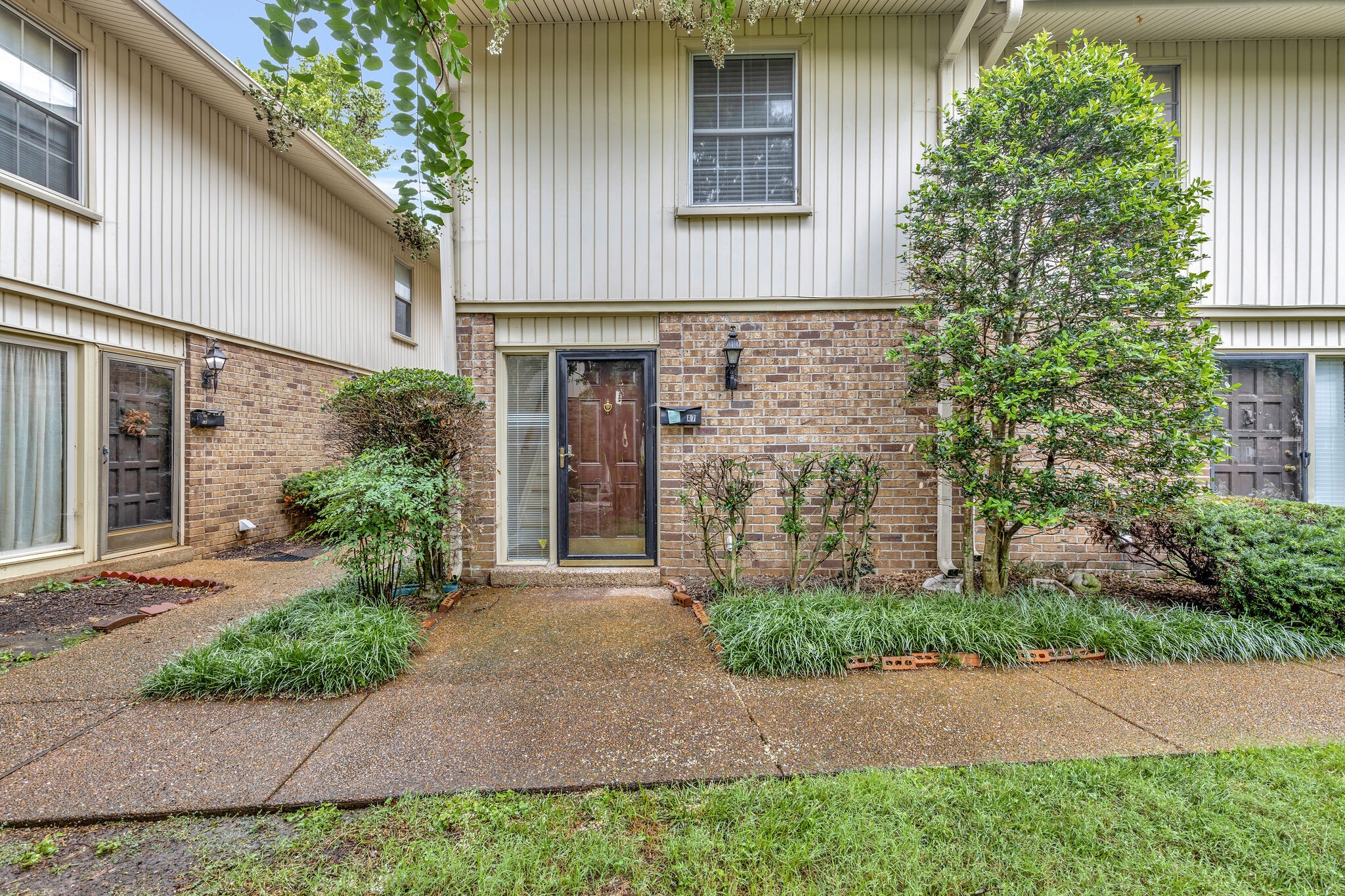 2116 Hobbs Road, Unit A7 Nashville, TN 37215 - Photo 1 of 12 a front view of a house with garden
