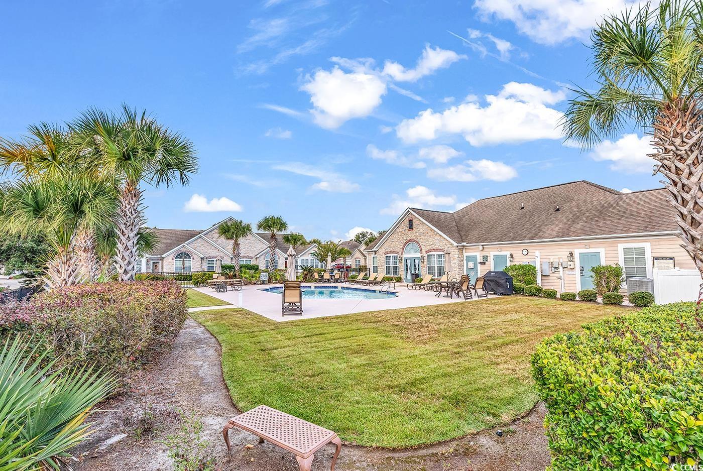 145 Stonegate Boulevard, Unit 145 Murrells Inlet, SC 29576 - Photo 35 of 40 View of swimming pool featuring a yard and a patio area