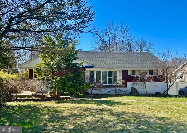 a backyard of a house with yard table and chairs
