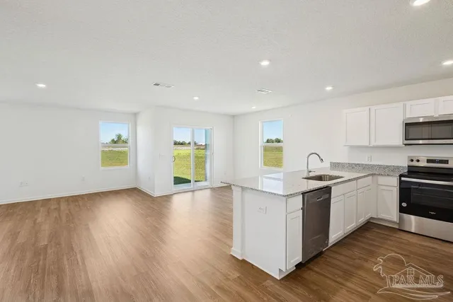 a kitchen with stove and cabinets