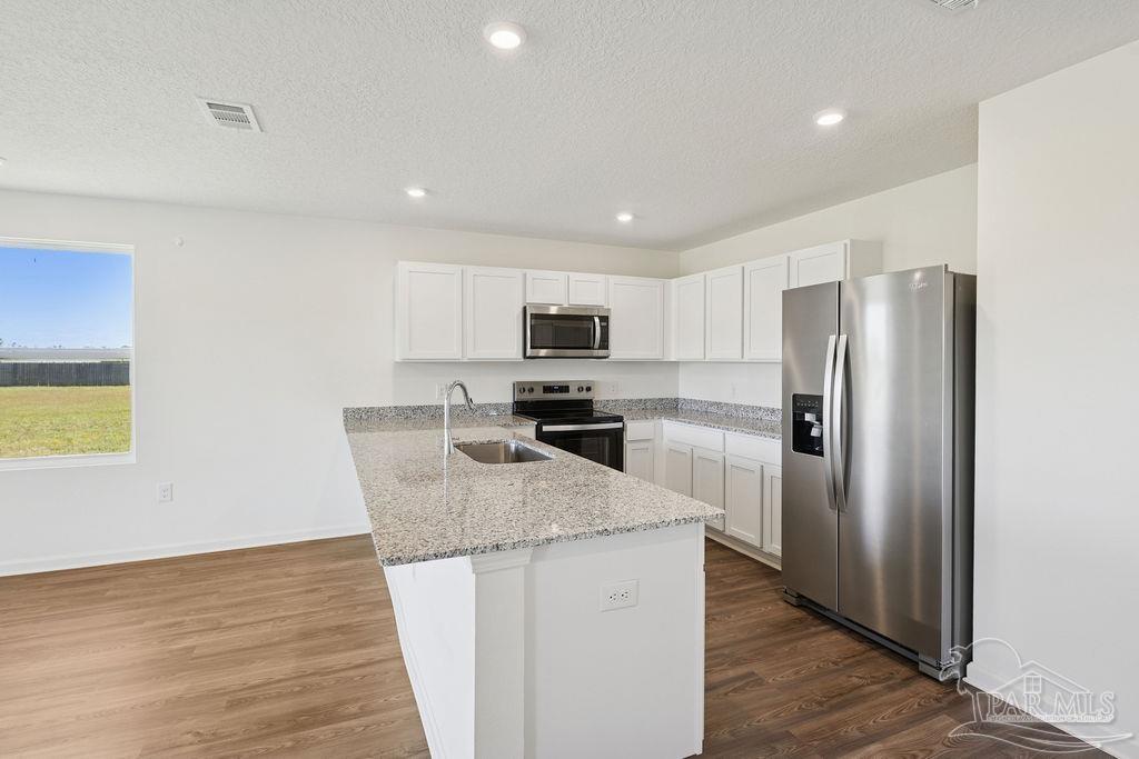 3422 Shell Road Jay, FL 32565 - Photo 18 of 31 a kitchen with granite countertop a refrigerator and a sink