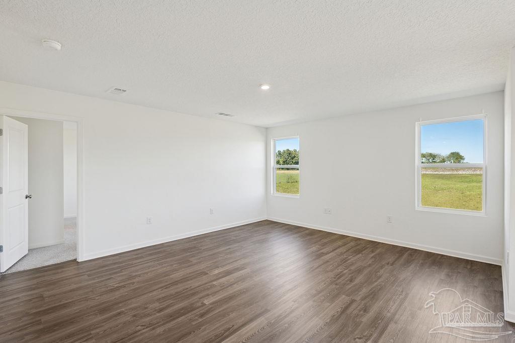 3422 Shell Road Jay, FL 32565 - Photo 21 of 31 a view of an empty room with wooden floor and a window