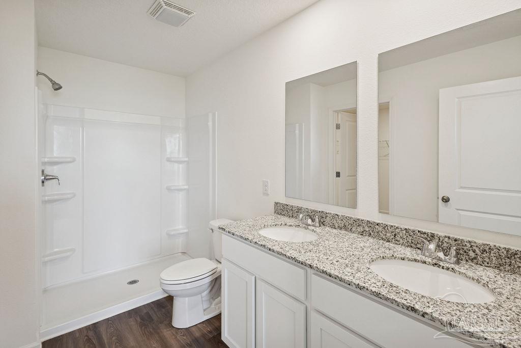 3422 Shell Road Jay, FL 32565 - Photo 26 of 31 a bathroom with a granite countertop toilet a sink and a mirror