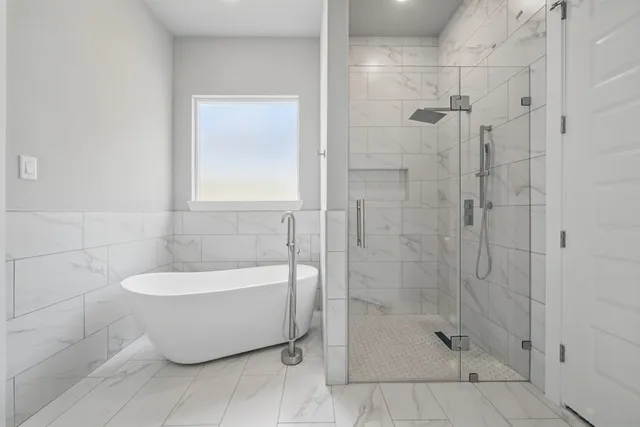 a bathroom with a bathtub and shower
