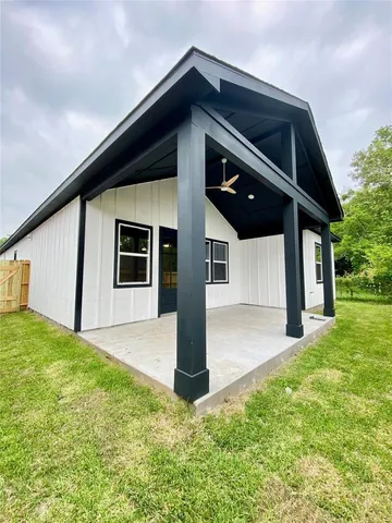 a front view of a house with a yard garage and trees