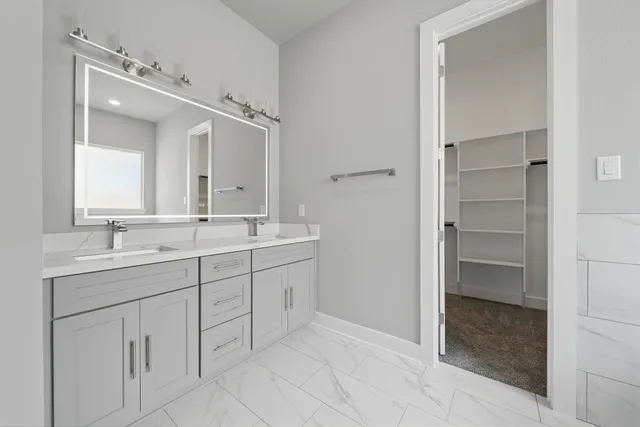 a bathroom with a double vanity sink and a mirror