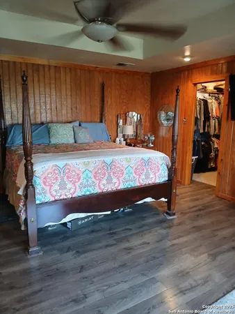 a bedroom with a bed and a large window