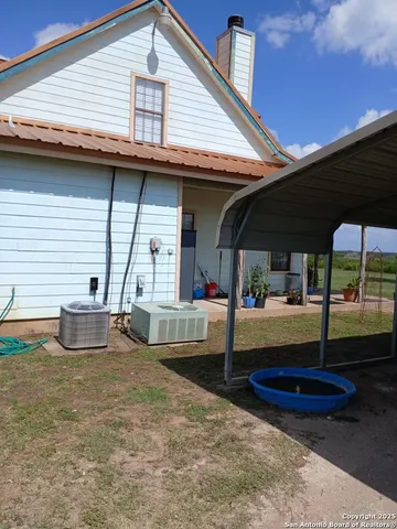 a view of a house with backyard and porch