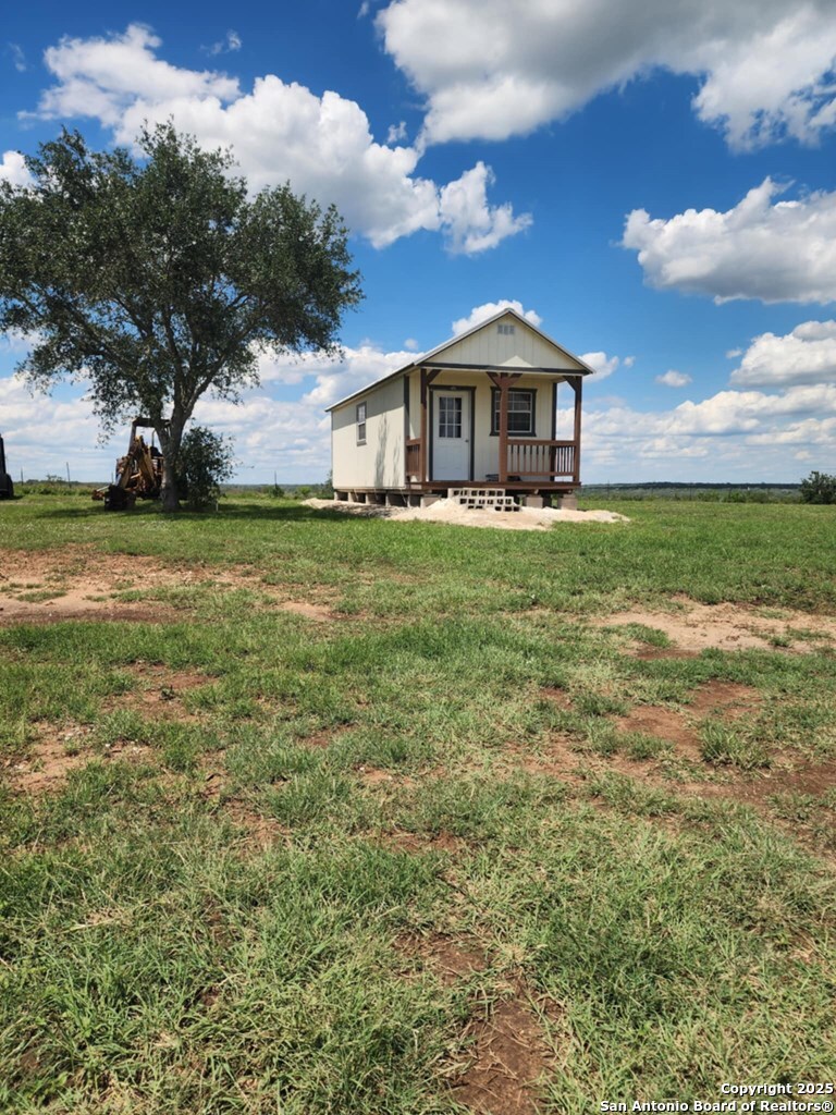 1121 Colony Road Beeville, TX 78102 - Photo 7 of 19 a front view of a house with garden
