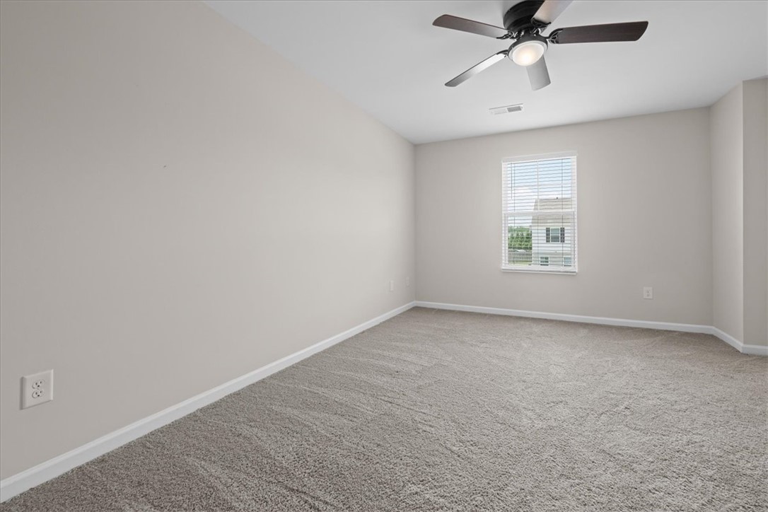 115 Adger Road Pendleton, SC 29670 - Photo 16 of 36 A well-lit room offers comfort with soft carpeting and a ceiling fan for year-round ease.