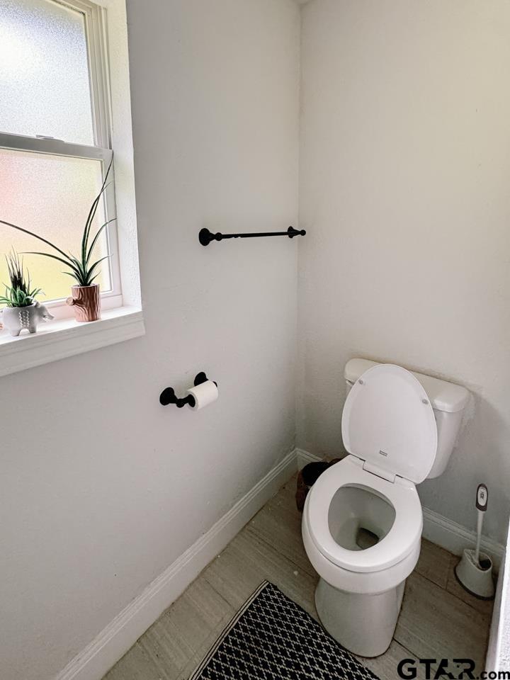 2411 Rodge Drive Tyler, TX 75701 - Photo 22 of 42 a bathroom with a toilet and a window