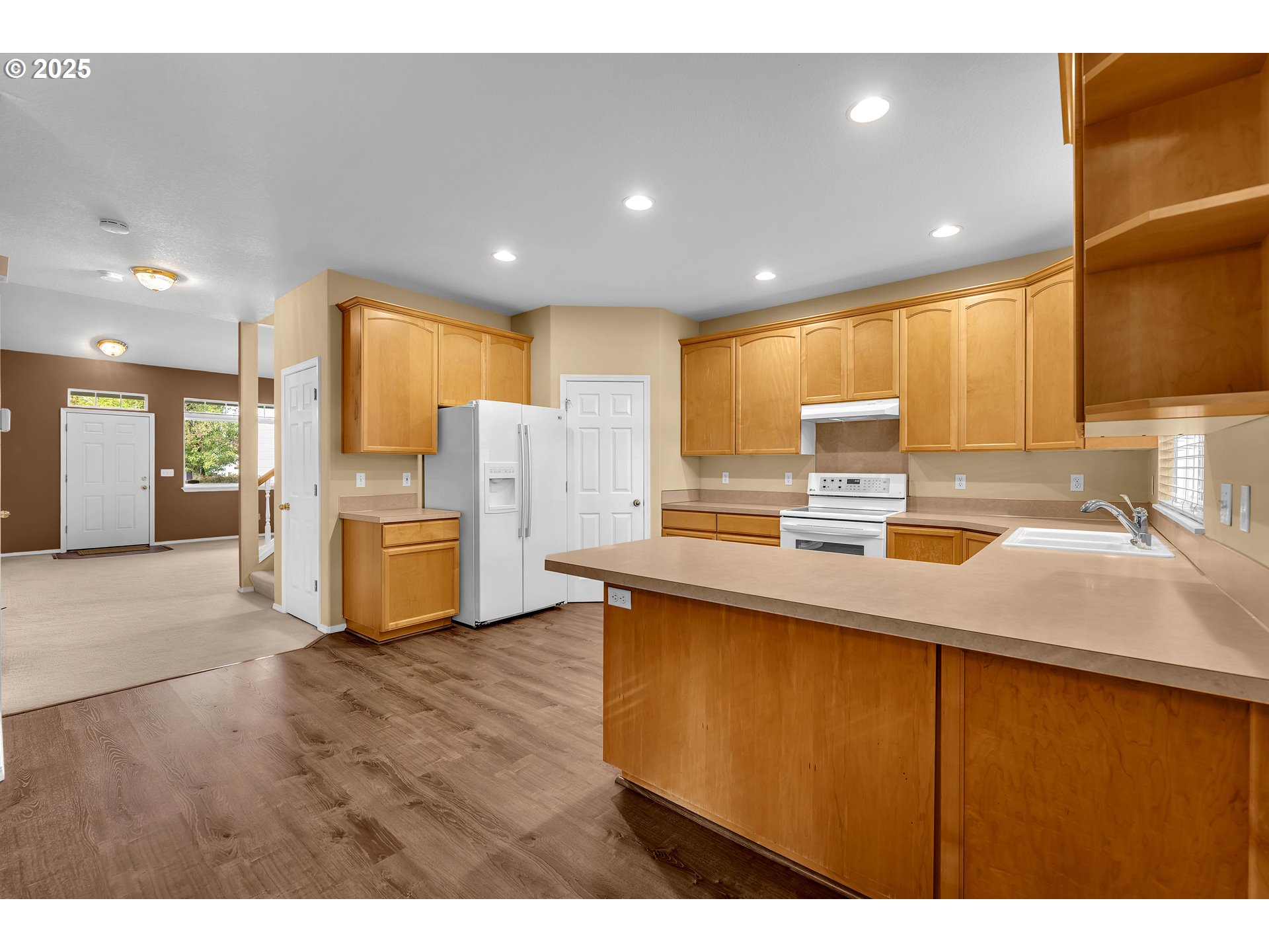 19509 Southeast 33rd Street Camas, WA 98607 - Photo 14 of 37 a kitchen with stainless steel appliances kitchen island granite countertop a sink refrigerator and cabinets