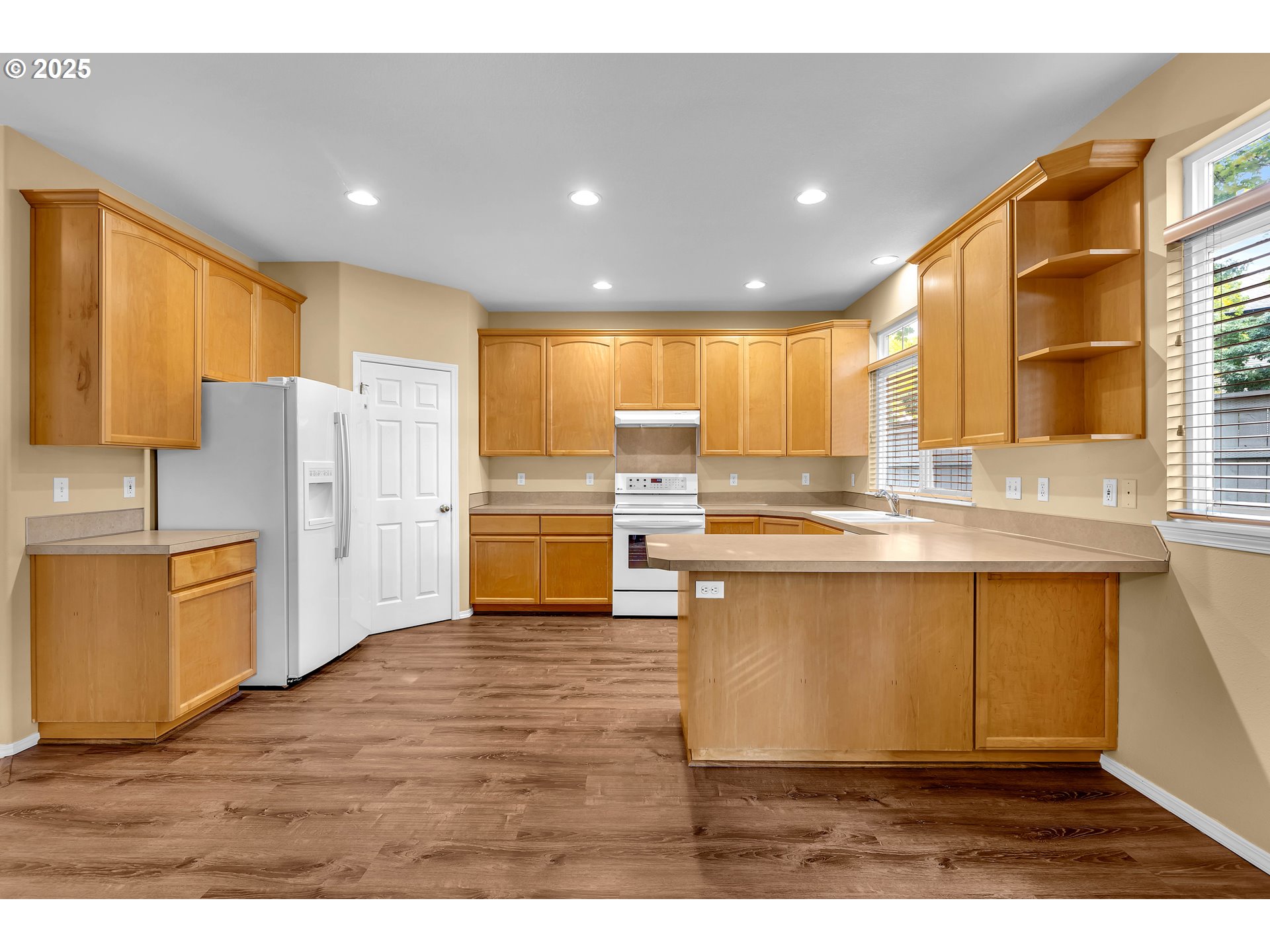 19509 Southeast 33rd Street Camas, WA 98607 - Photo 15 of 37 a kitchen with refrigerator cabinets and wooden floor