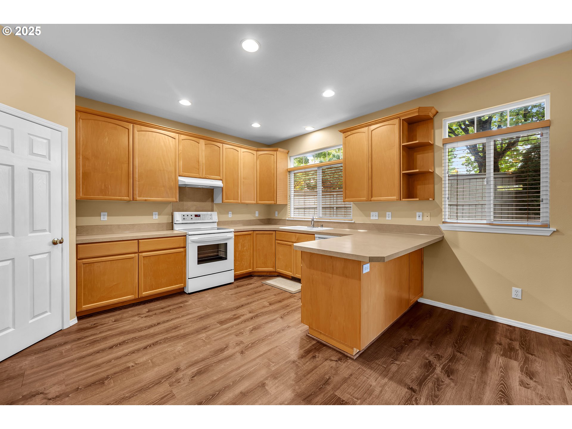 19509 Southeast 33rd Street Camas, WA 98607 - Photo 8 of 37 a kitchen with stainless steel appliances granite countertop a stove a sink and a refrigerator