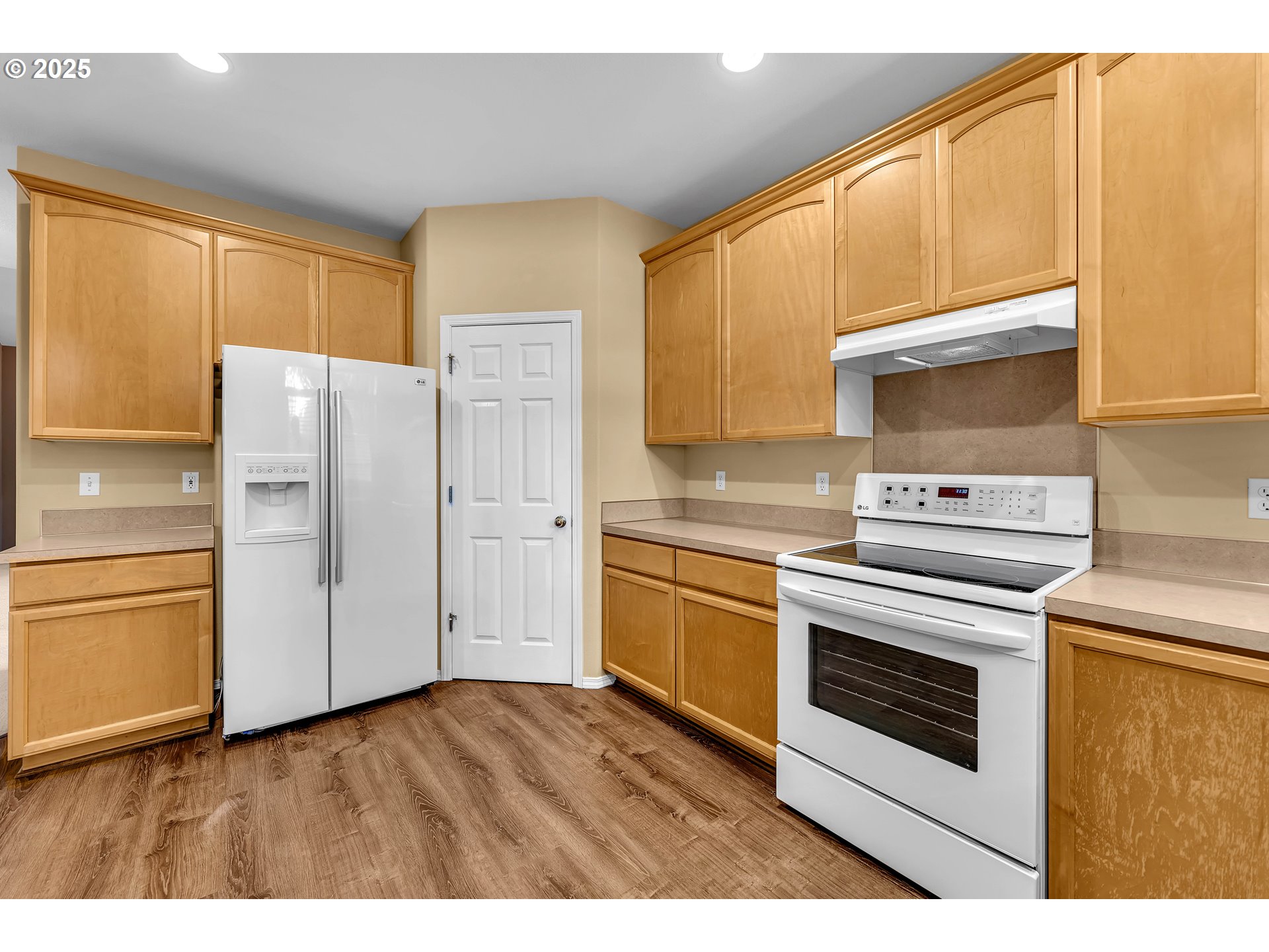 19509 Southeast 33rd Street Camas, WA 98607 - Photo 10 of 37 a kitchen with stainless steel appliances white cabinets and a refrigerator