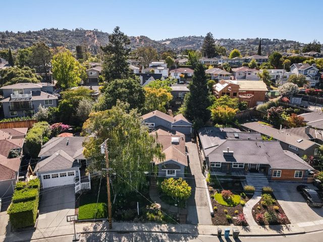 an aerial view of a houses with a lake