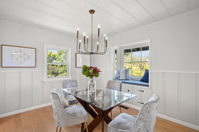 a view of a dining room with furniture and a window