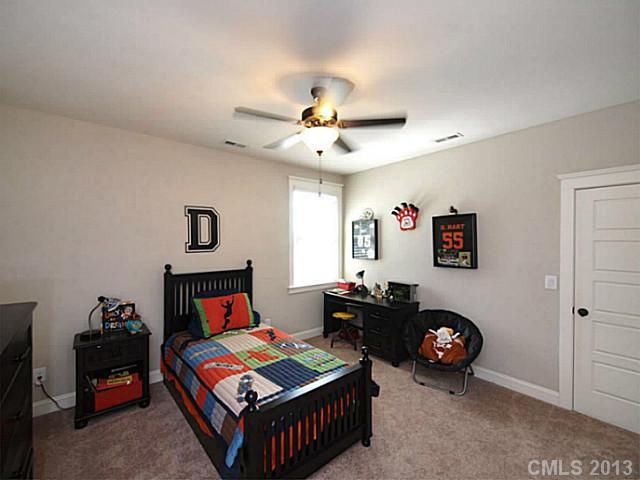 803 Harvest Pointe Drive Fort Mill, SC 29708 - Photo 14 of 16 a bedroom with furniture and a chandelier