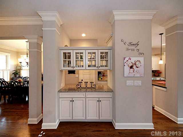 803 Harvest Pointe Drive Fort Mill, SC 29708 - Photo 3 of 16 a hallway with painting on the wall and a refrigerator