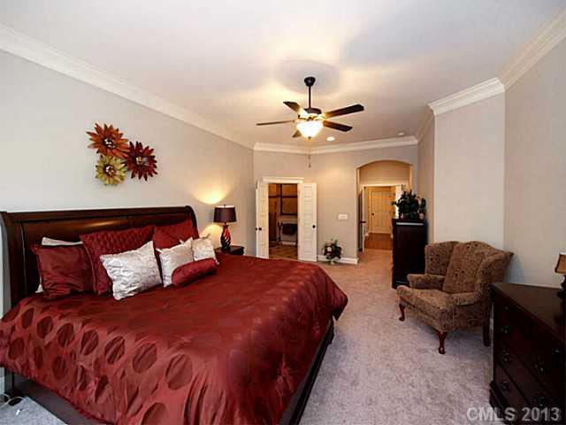 803 Harvest Pointe Drive Fort Mill, SC 29708 - Photo 8 of 16 a bedroom with a bed and a chandelier