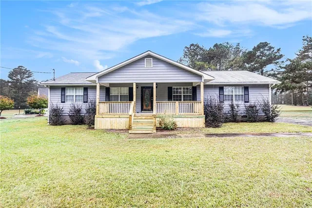 a view of a house with pool and a yard