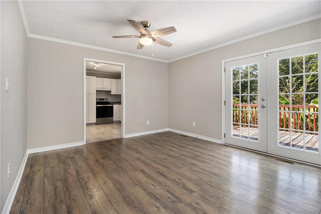 150 Dub Walker Road Jackson, GA 30233 - Photo 11 of 32 a view of an empty room with a window and wooden floor