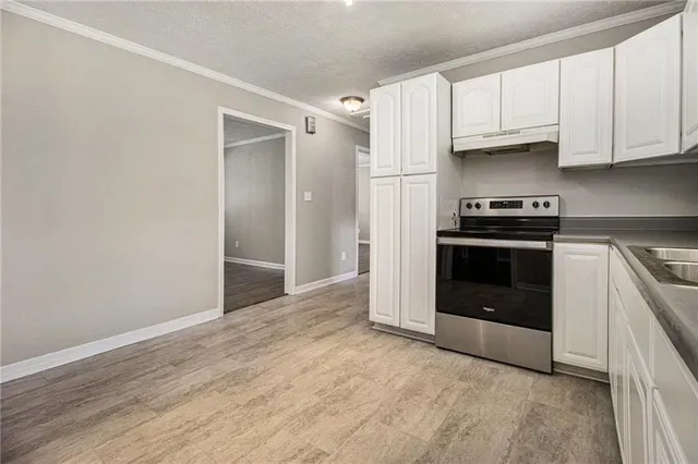 a kitchen with granite countertop a stove and a refrigerator