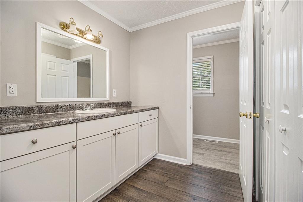 150 Dub Walker Road Jackson, GA 30233 - Photo 24 of 32 a bathroom with a granite countertop sink and a mirror