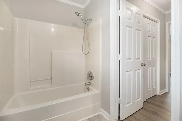 a bathroom with a shower and a bath tub