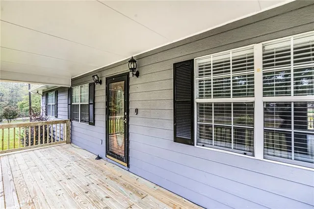 a view of a deck with wooden floor and fence