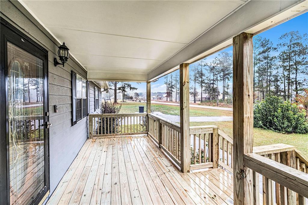 150 Dub Walker Road Jackson, GA 30233 - Photo 28 of 32 a view of a balcony with wooden floor
