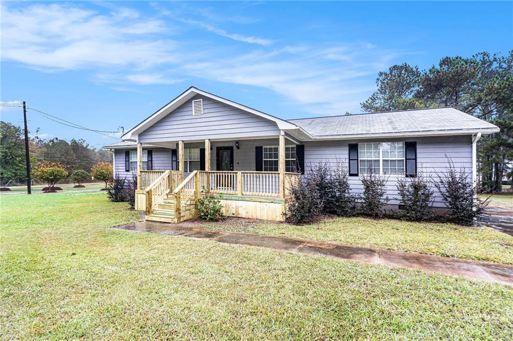 150 Dub Walker Road Jackson, GA 30233 - Photo 3 of 32 a view of a house with a yard patio and fire pit
