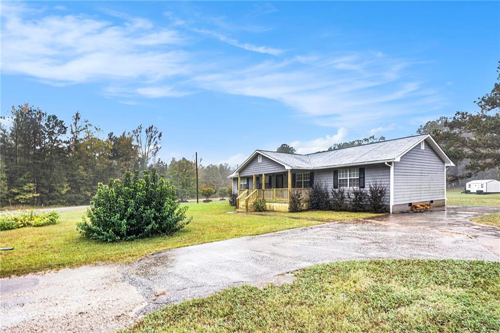 150 Dub Walker Road Jackson, GA 30233 - Photo 4 of 32 a view of a house with a big yard and large trees