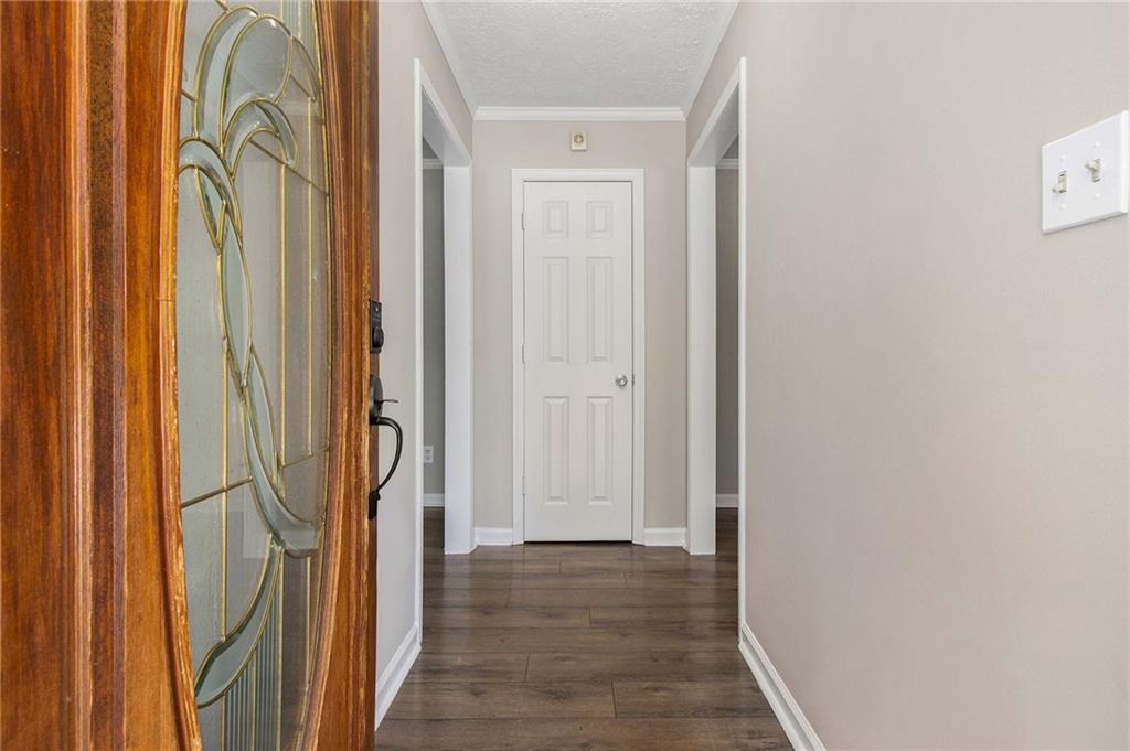 150 Dub Walker Road Jackson, GA 30233 - Photo 5 of 32 a view of a hallway with wooden floor and door