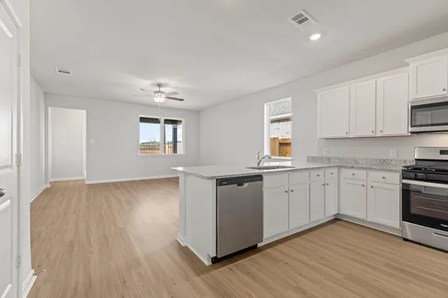 a kitchen with granite countertop white cabinets and white appliances