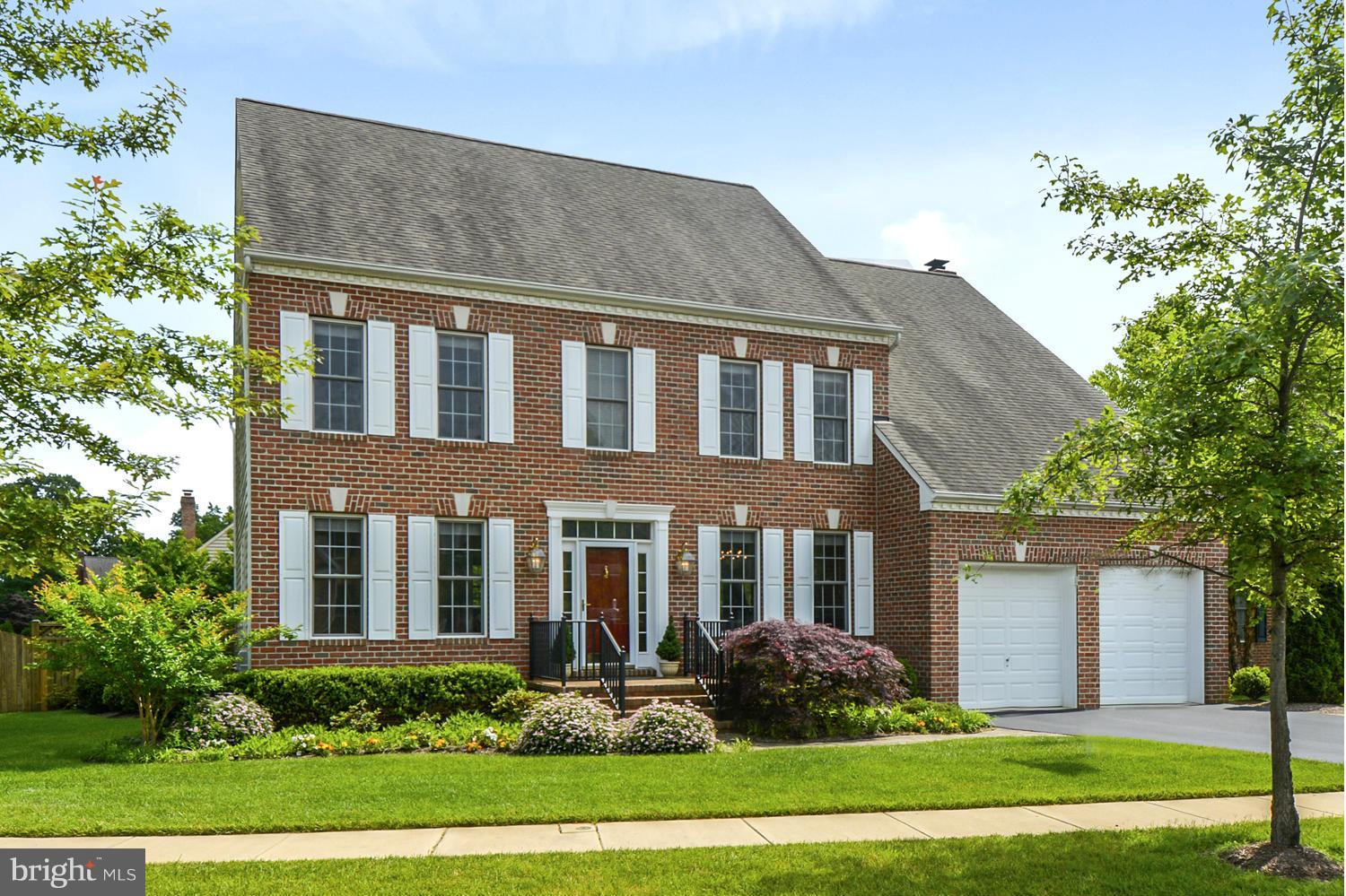 a front view of a house with garden and porch