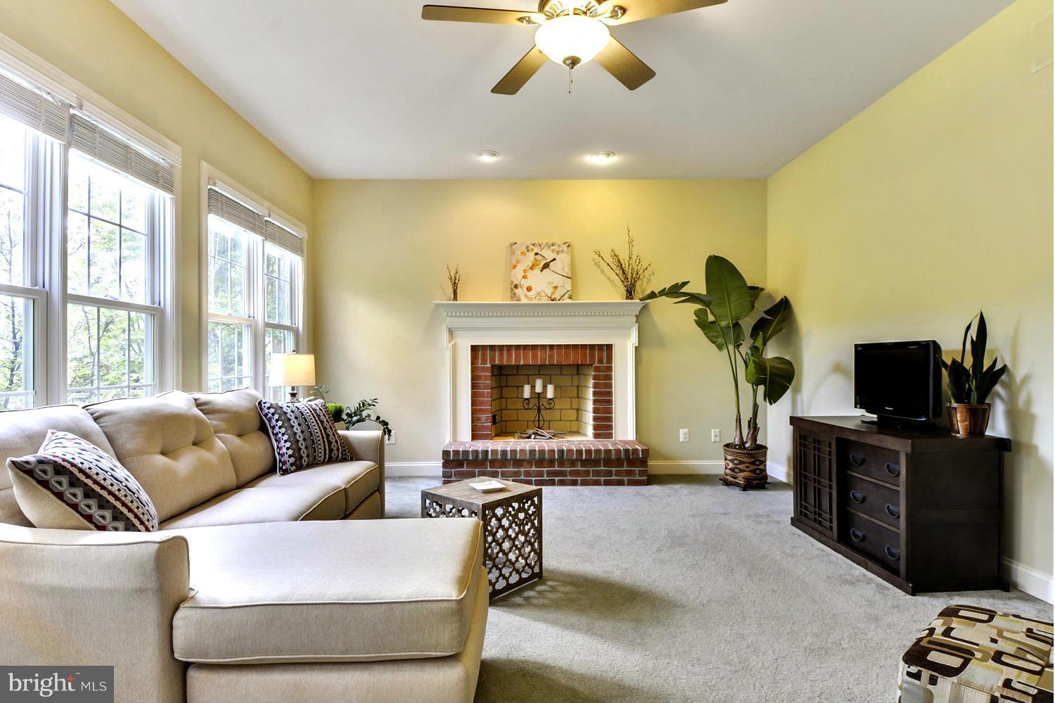 505 Tremont Circle Annapolis, MD 21409 - Photo 15 of 30 a living room with furniture a fireplace and a flat screen tv